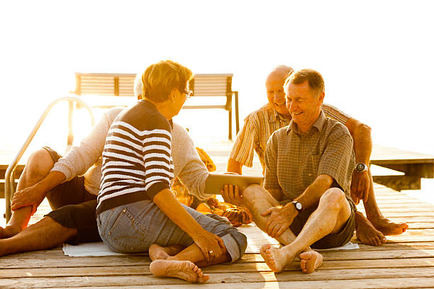 istock happy silver surfers with tablet at sunset 513754499