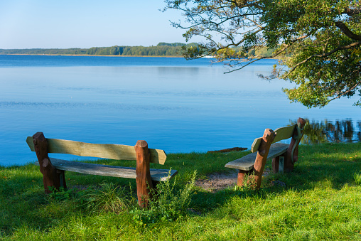 benches at a lake in summer sunset