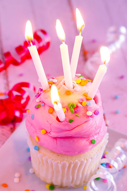istock Vanilla Cupcakes with Pink Frosting and Candles 513755389