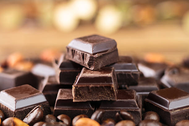 istock Dark chocolate cubes, coffee beans and peanuts, close-up 513756372