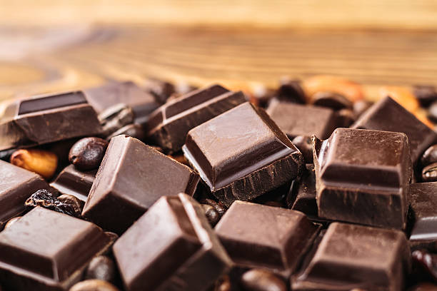 istock Dark chocolate cubes, coffee beans, peanuts and raisins 513756658