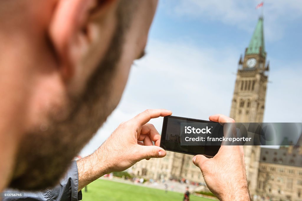 tourist taking a picture of the ottawa parliament - canada 25-29 Years Stock Photo