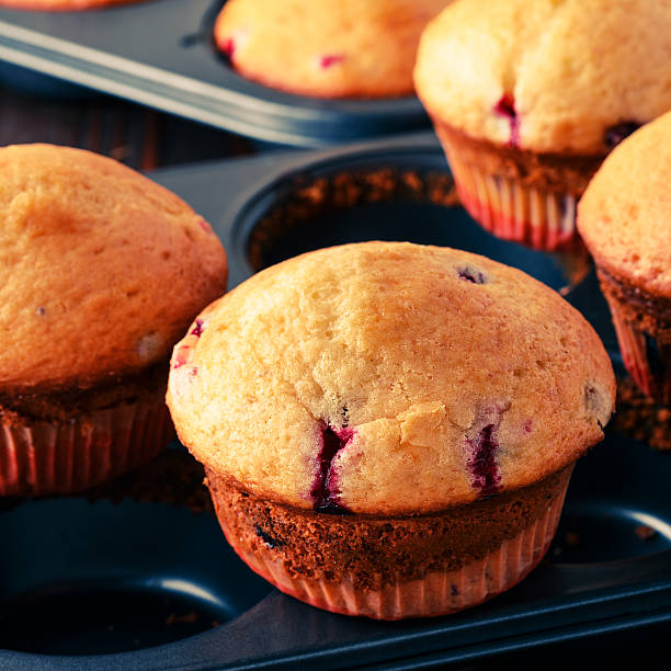 istock Cranberry muffins on wooden background. 513761958