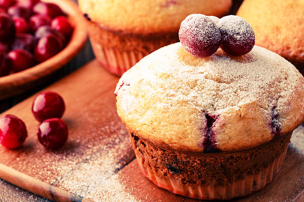 istock Cranberry muffins on wooden background. 513762074