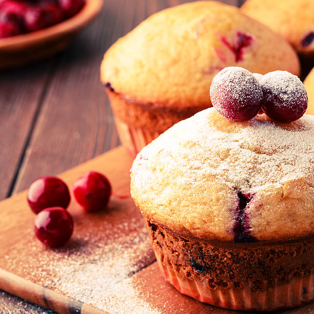 istock Cranberry muffins on wooden background. 513762150