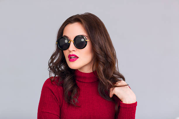 istock Attractive woman in glasses standing on grey background 513762978