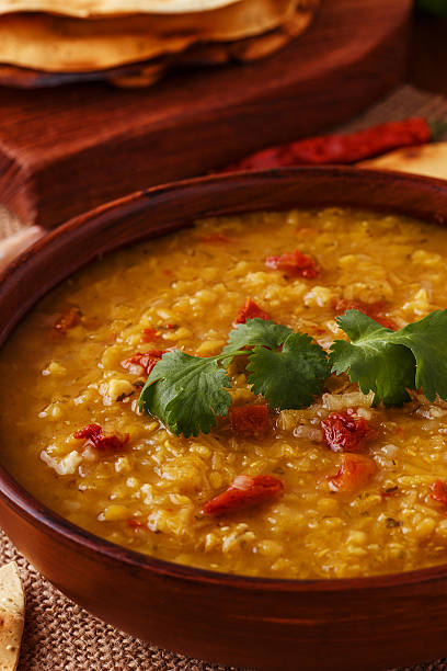 istock Thick indian red lentil soup with indian flat bread. 513763180
