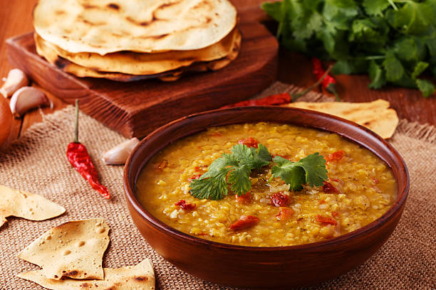 istock Thick indian red lentil soup with indian flat bread. 513763226