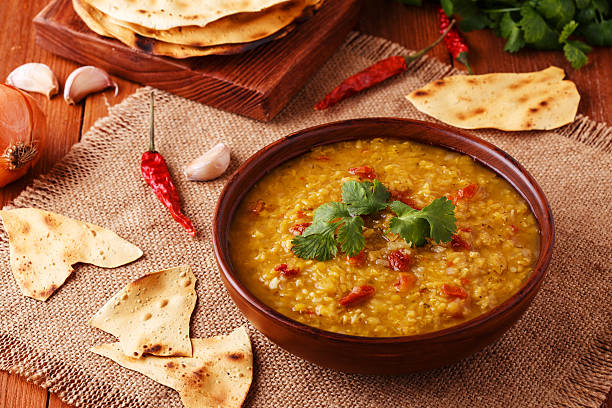 istock Thick indian red lentil soup with indian flat bread. 513763310
