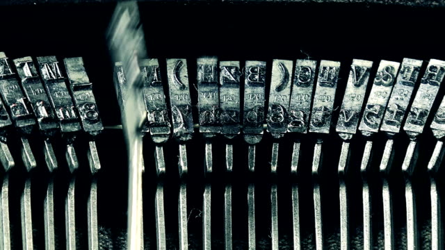 Type hammers of an old manual typewriter machine, close up