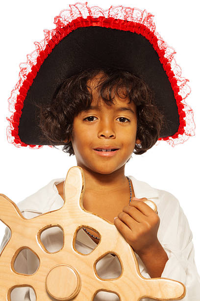 istock Portrait of a boy playing pirate steering helm 513780751