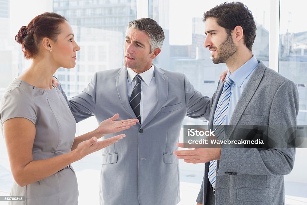 Businesswoman arguing with co-worker Businesswoman arguing with co-worker in office Discussion Stock Photo