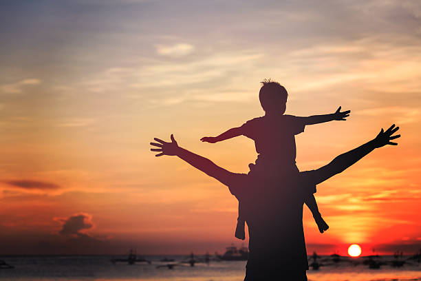 istock father and son on sunset beach 513782041