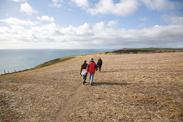 istock People Walking Along Coastal Cliff 513782371