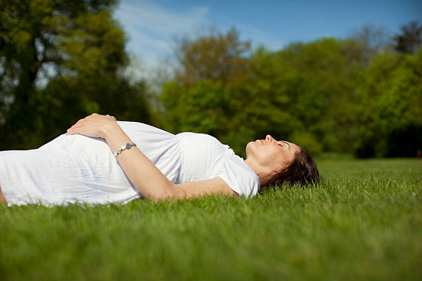 istock Pregnant Woman Lying On Grass 513782407