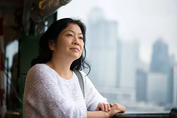 Photo of Mature Asian Woman Riding Ferry