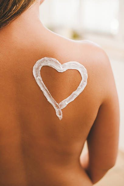 Moisturizer heart on back of woman