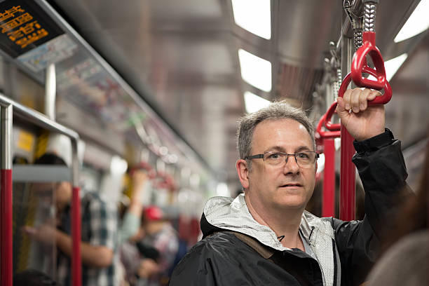 istock Mature Man Riding Train in Hong Kong 513784063