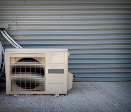 air conditioneer on the corrugated metal wall