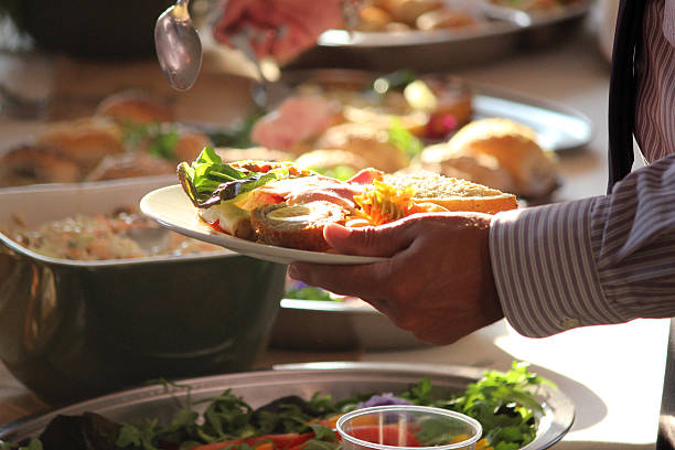 istock Buffet image, person piling plate with party food, sandwich, Scotch-egg 513784649