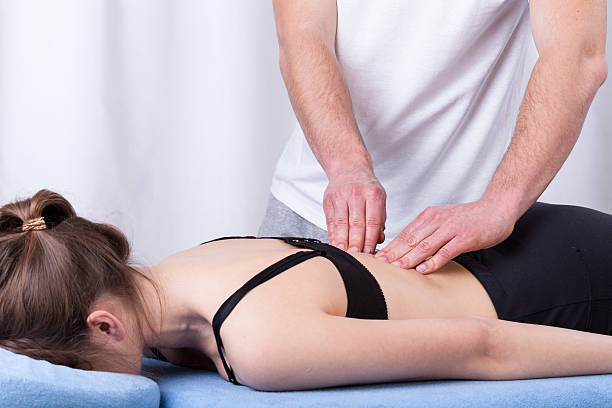 istock Physiotherapist touching muscle of the back 513786637
