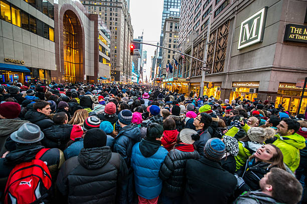 Crowds celebrating New Year on Times Square, NYC New York, USA - December 31, 2013: Crowds gathering to Times Square from all surrounding streets, to stay all night and celebrate New Year on Times Square, NYC times square new years eve stock pictures, royalty-free photos & images