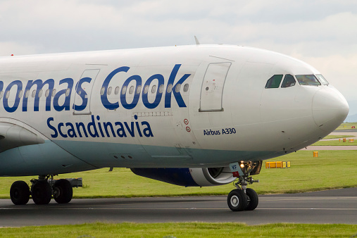 Manchester, United Kingdom - June 14, 2014: Thomas Cook Airbus A330, taxiing on Manchester International Airport. Thomas Cook reported slowdown in German holiday bookings on September, 2014. According to company, this is due to geopolitical events.