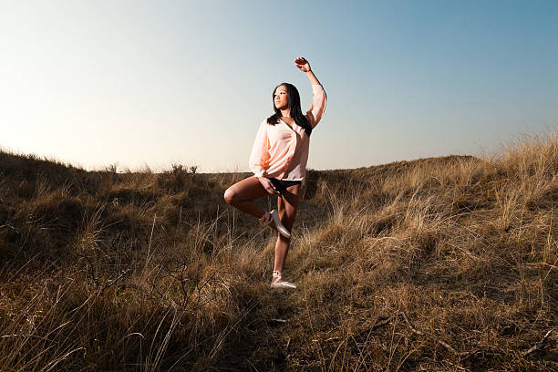 istock Pretty black girl posing in dune landscape. 513787667