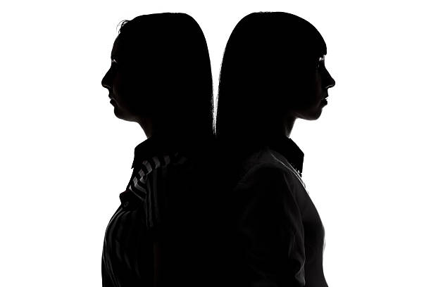 istock Silhouette of women standing back-to-back 513792236
