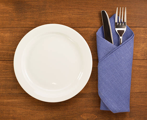 istock knife and fork with napkin on wood 513792810