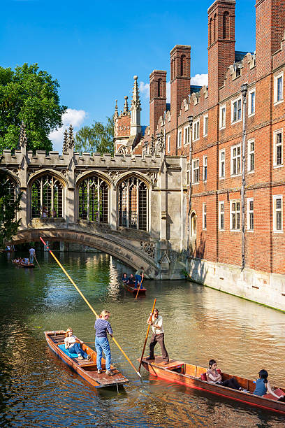 Bridge of Sighs of St John's College, Cambridge, United Kingdom Cambridge, Cambridgeshire, United Kingdom - June 24, 2006: Tourists on punt trip (sightseeing with boat) along River Cam near Bridge of Sighs of St John's College cambridge england photos stock pictures, royalty-free photos & images