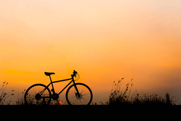 istock Sunset silhouette and bicycle on beautiful sky 513793212