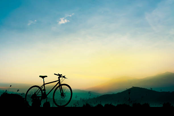 istock Sunset silhouette and bicycle on beautiful sky 513793568