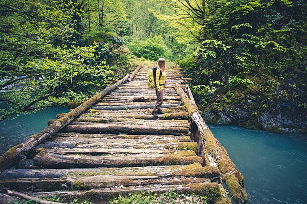 istock Woman Traveler with backpack hiking on bridge 513794578