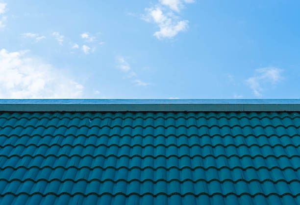 istock aqua tile roofing and blue sky 513794940