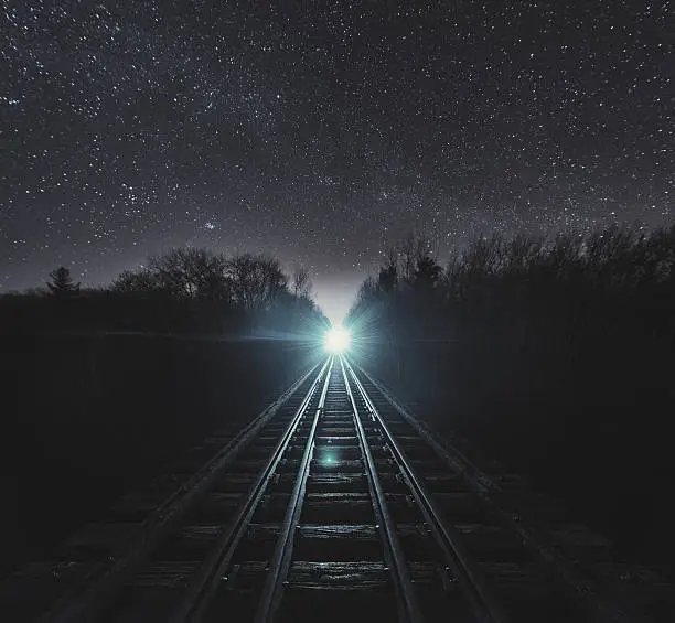 Standing in the middle of a bridge with a train fast approaching.  Long exposure.