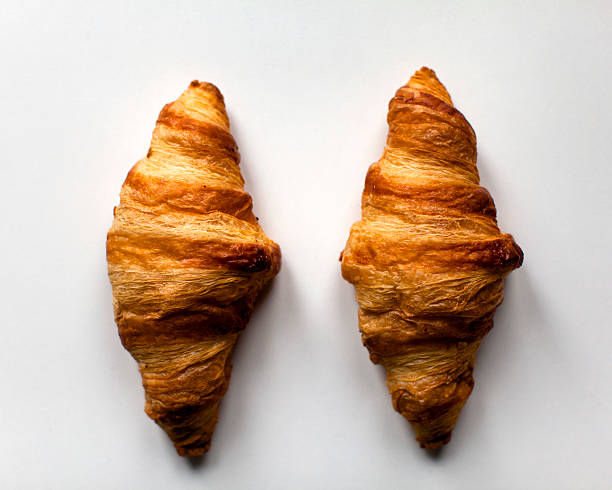 istock Two french croissants on white background 513795836