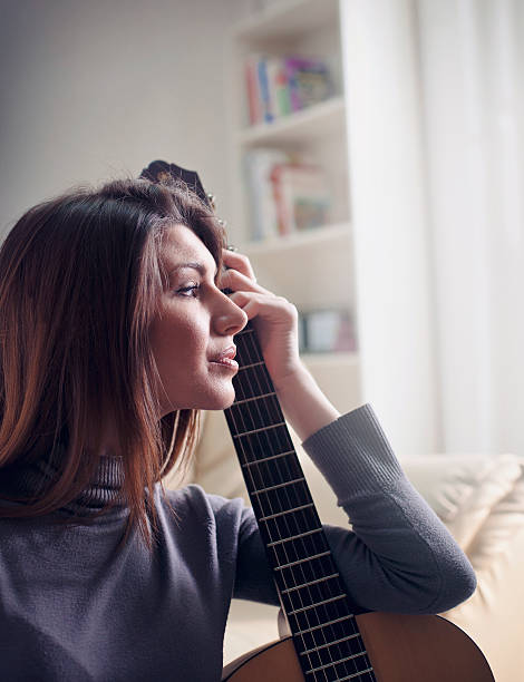 istock Musician woman playing guitar 513796586
