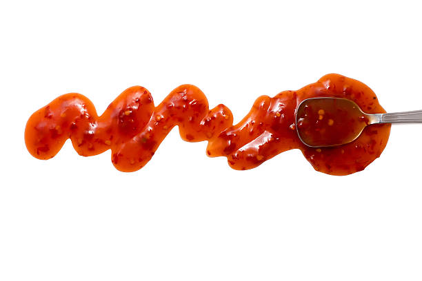 splashes, droplets and spilled chili sauce with a spoon