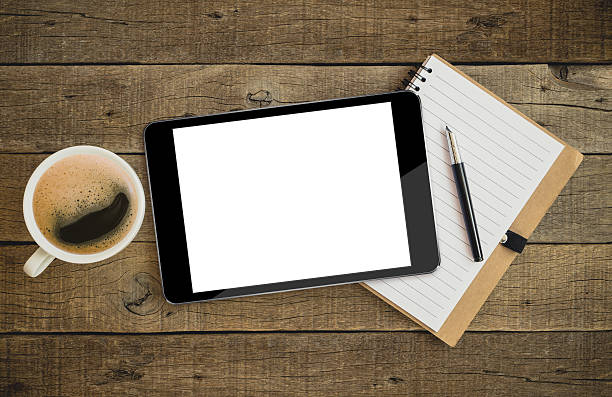 istock tablet on wood desk on top view 513797876