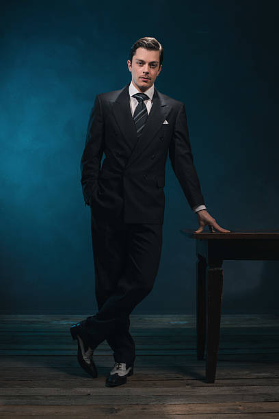 istock Retro 1940s business man in suit standing next to desk. 513798438