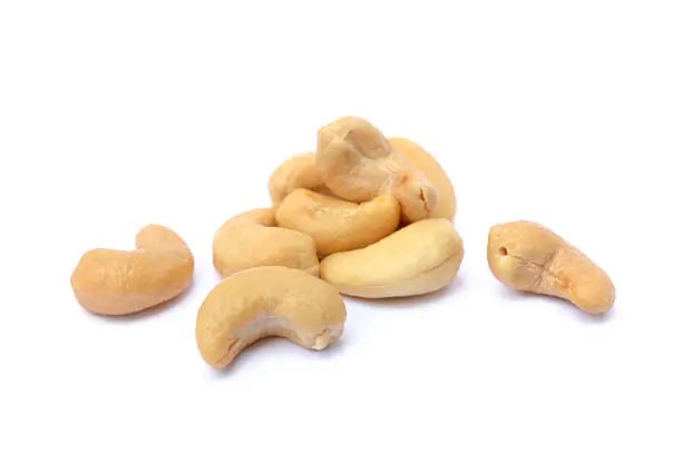 Peeled salted cashews isolated on a white background