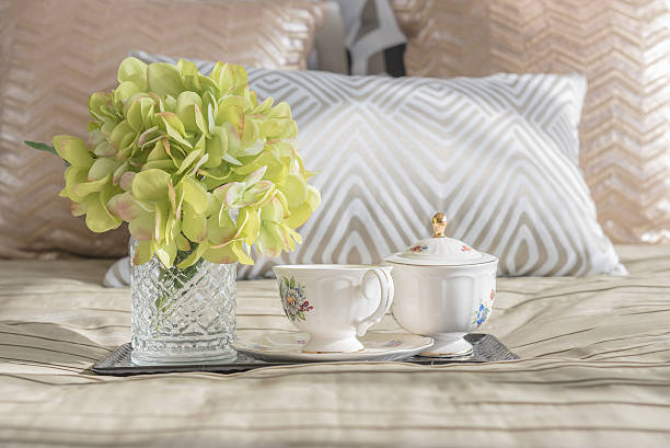 tea on wooden tray on bed at home