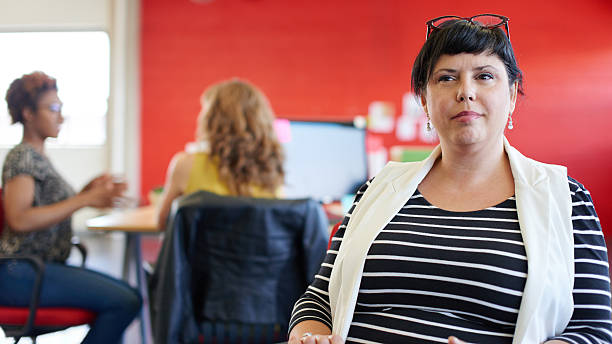 istock Confident female designer working on a digital tablet in red 513799646