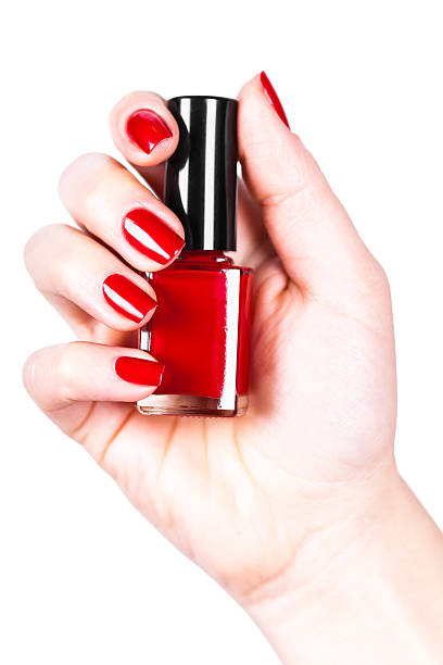 istock Red nail polish in a hand 513799762