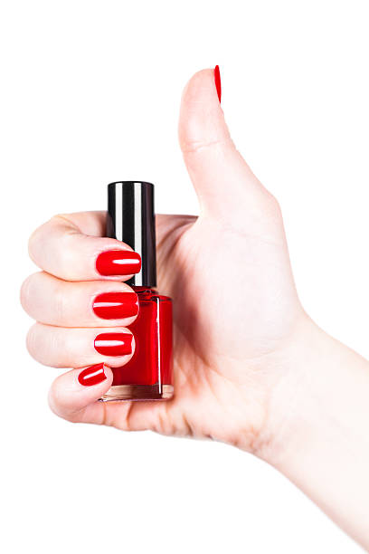 istock Red nail polish in a hand 513799806