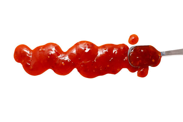 istock splashes, droplets and spilled spicy red salsa with a spoon 513802204