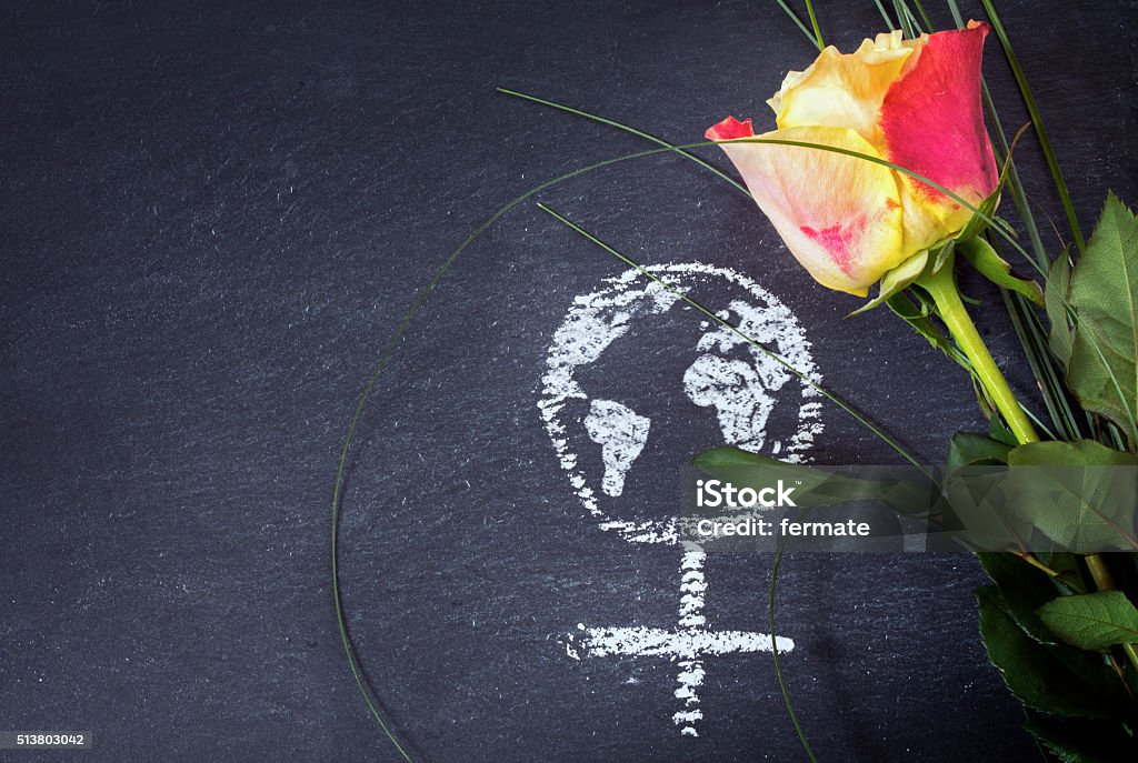 Rose and female sign with earth globe on a blackboard Rose and a chalk drawn female sign with earth globe on a blackboard, concept of  women's day, women's rights and feminism, copy space Day Stock Photo