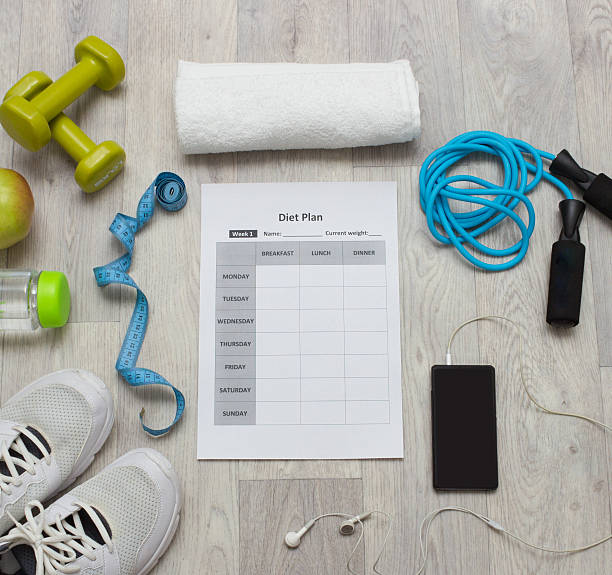 istock Various sport equipment with diet plan on wooden background 513805854