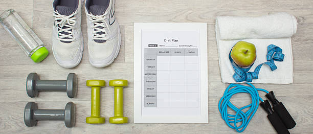 istock Various sport equipment with diet plan on wooden background 513806514